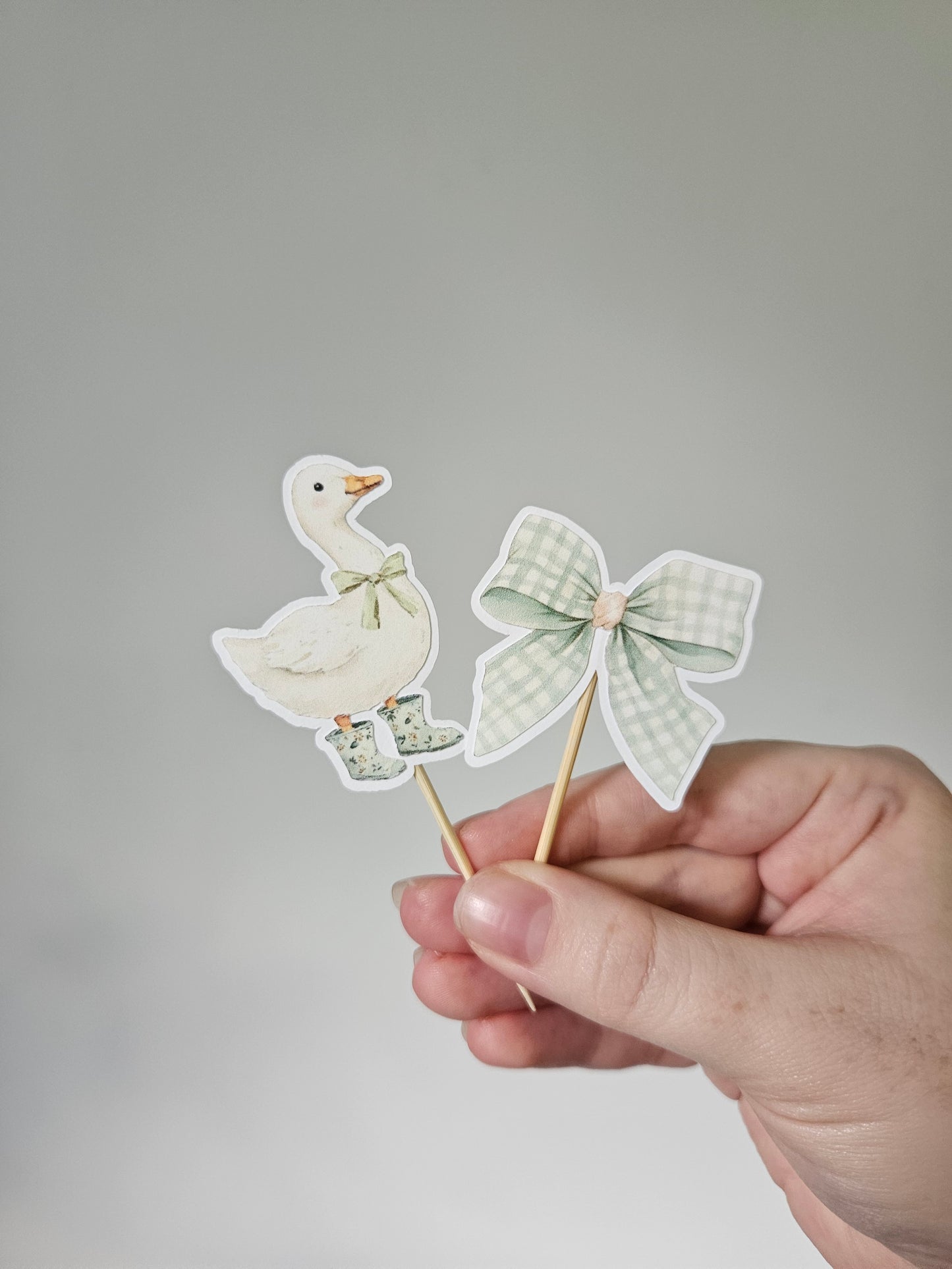 goose and bow cupcake topper on white background