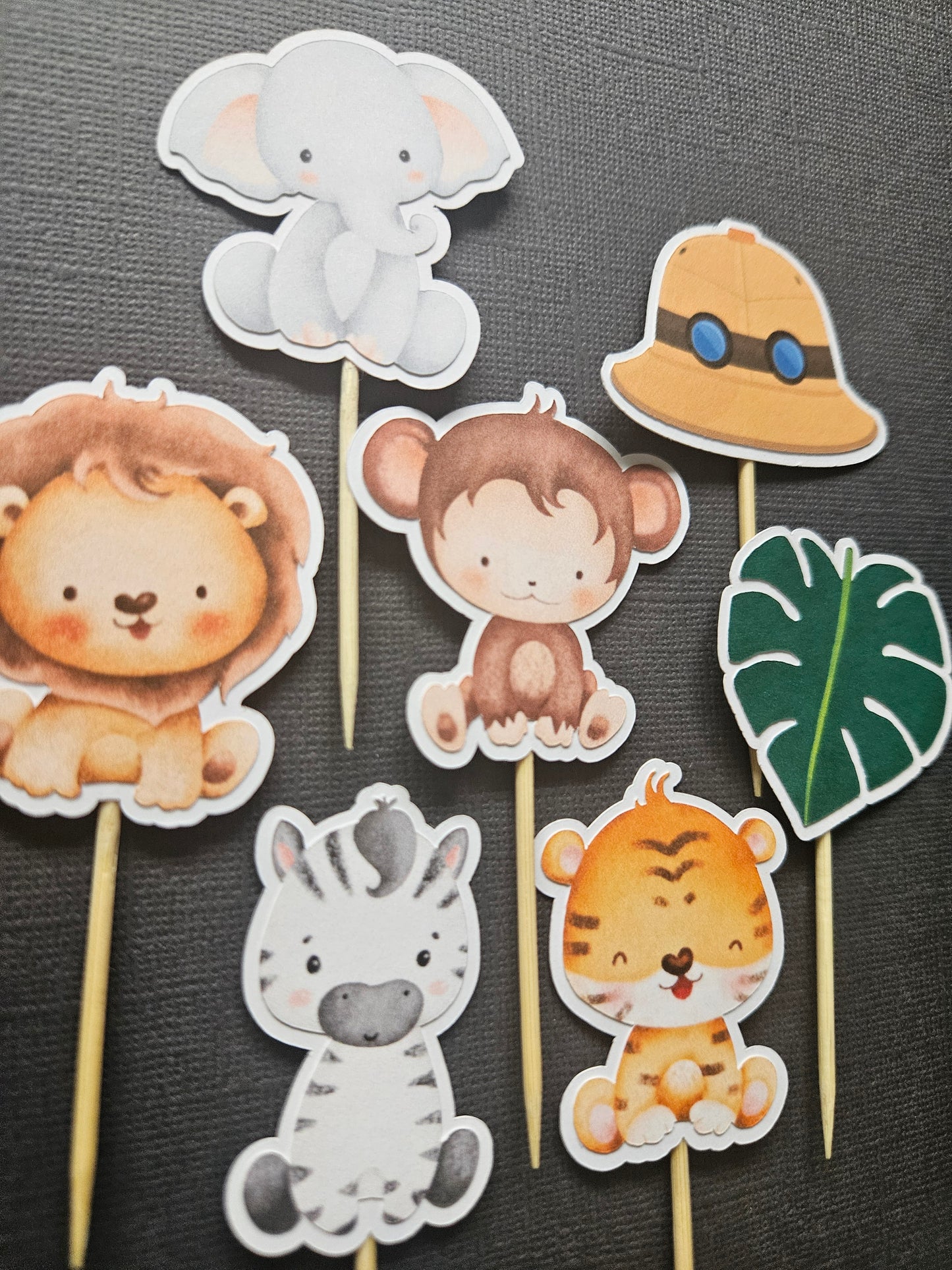 Range of safari cupcake toppers on black background