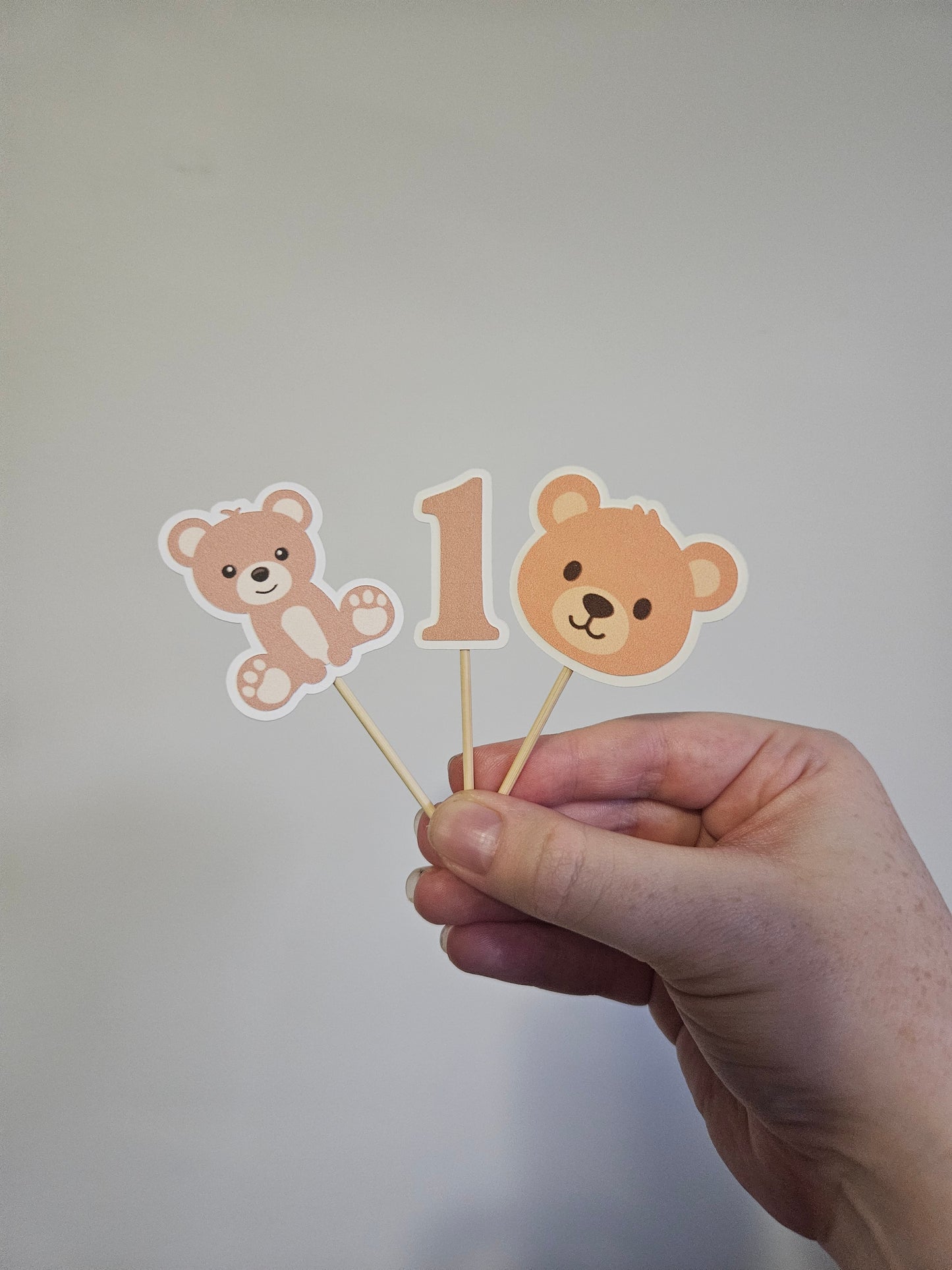Outline teddy bear cupcake toppers on white background