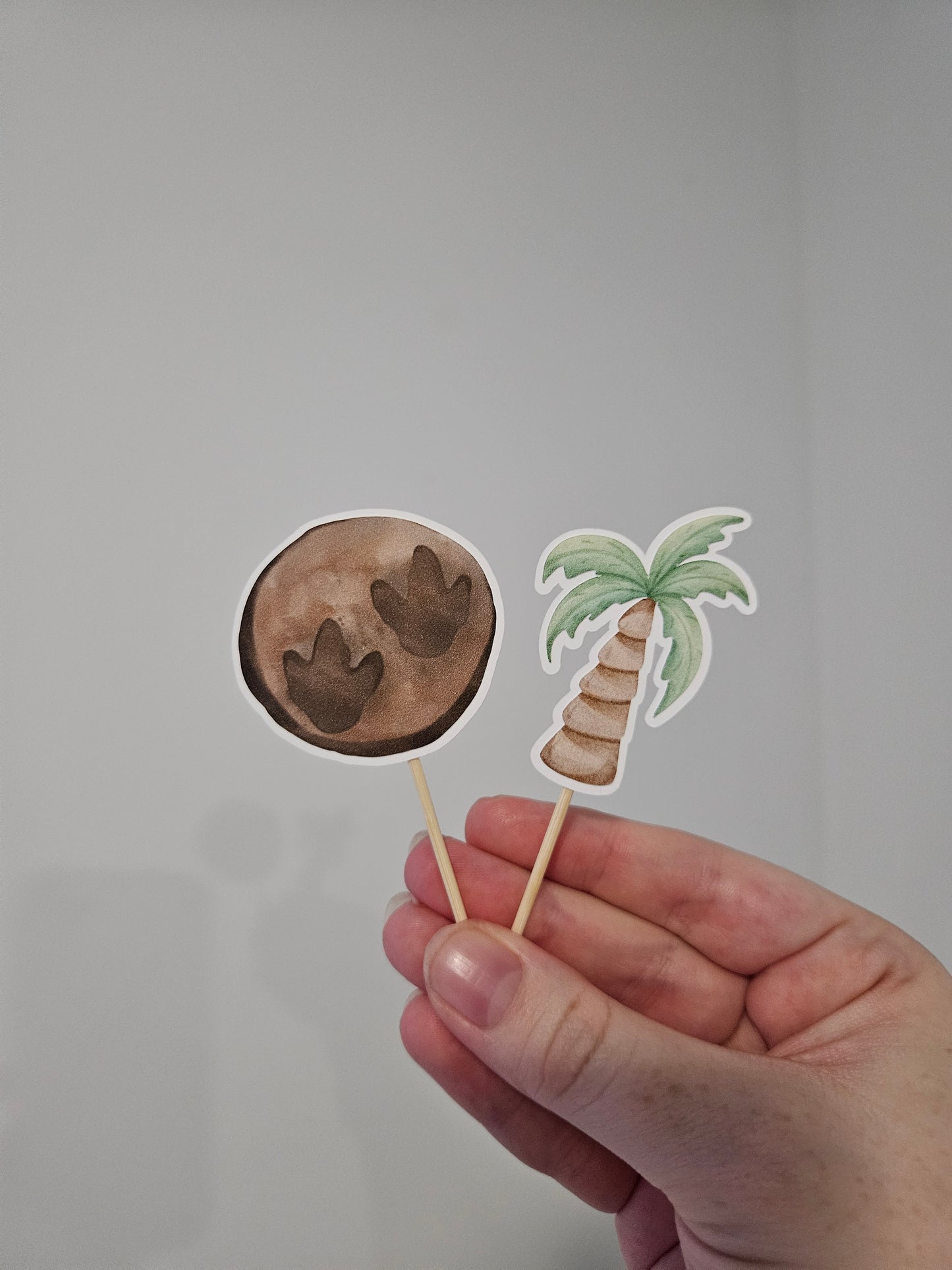 fossil and tree cupcake toppers on white background