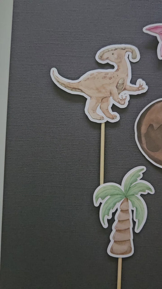 video of dino cupcake toppers on black background