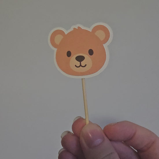 video of outline teddy bear cupcake topper on white background