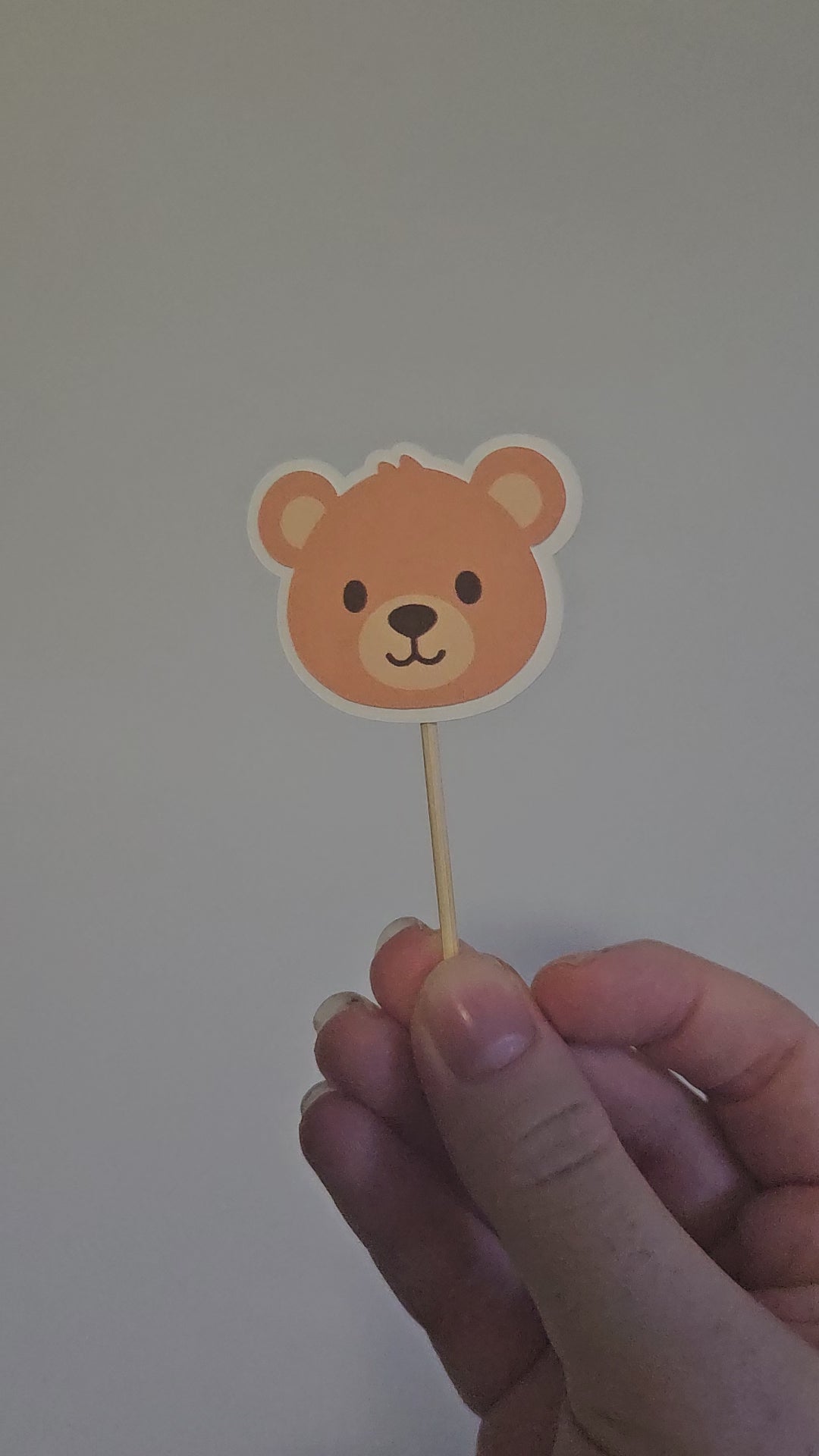 video of outline teddy bear cupcake topper on white background