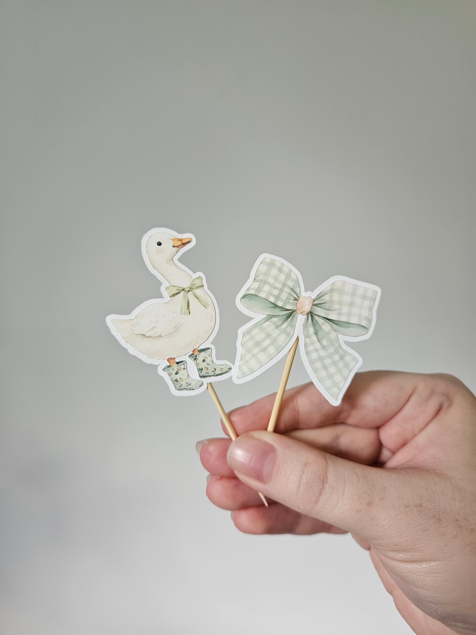 goose and bow cupcake topper on white background