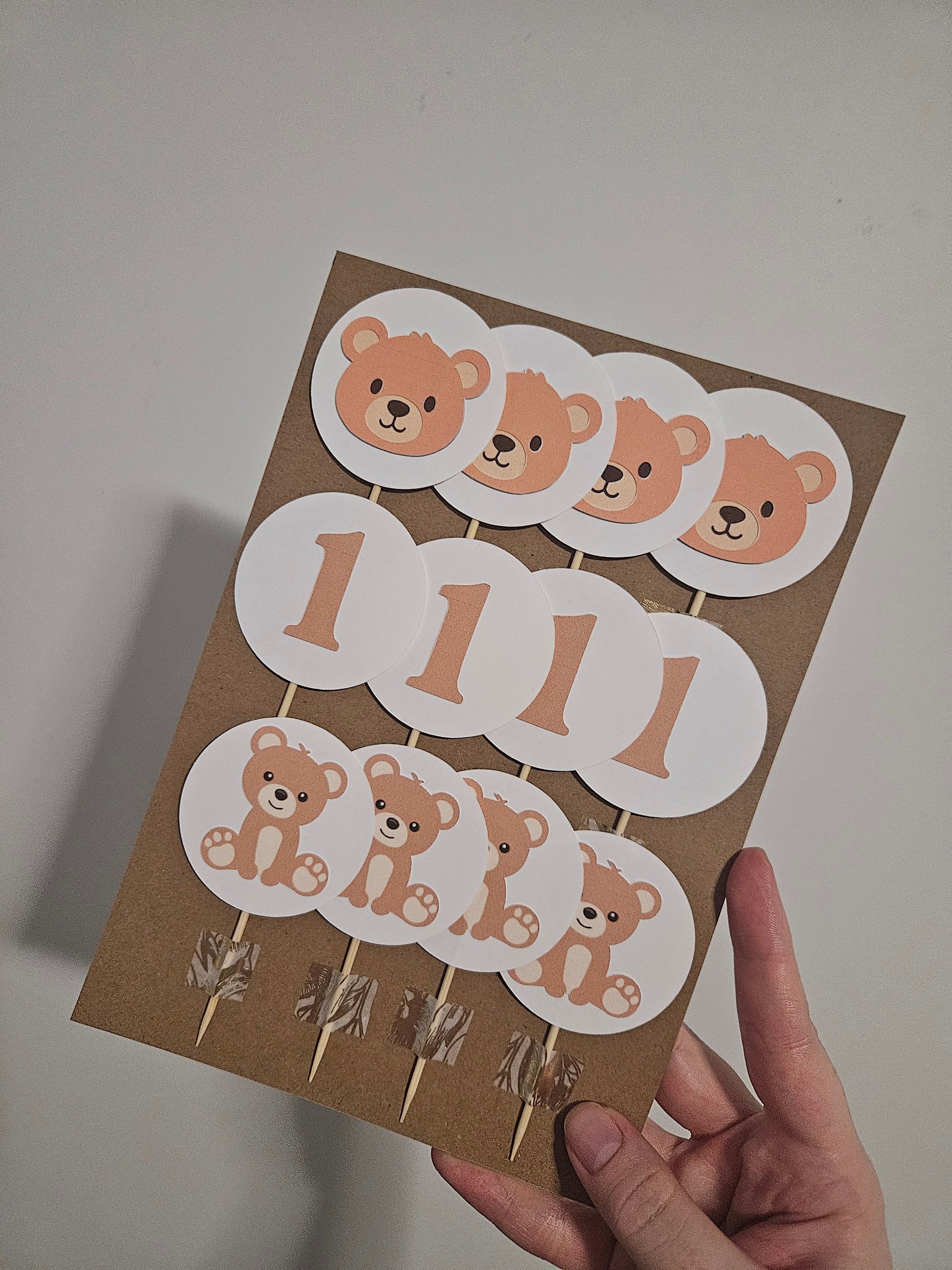 teddy bear and one cupcake toppers on card backing