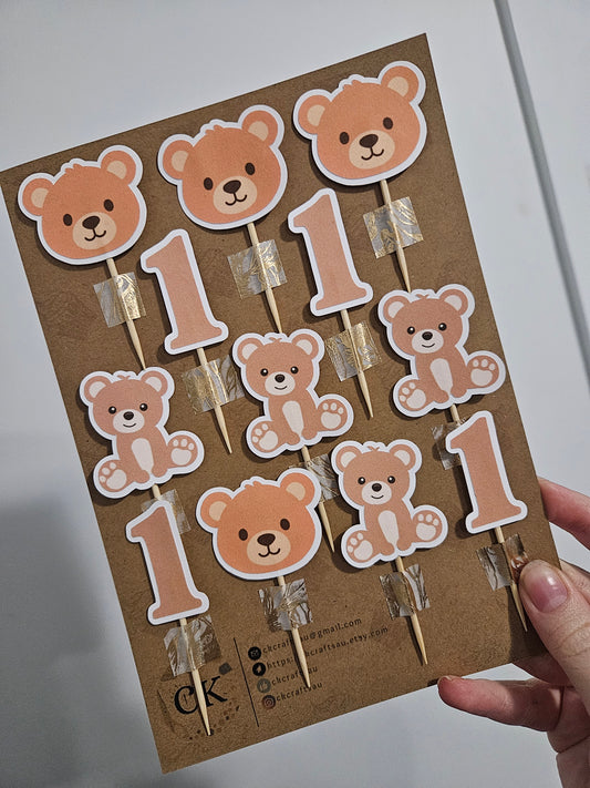 Card with teddy bear and one toppers on a cardboard backing