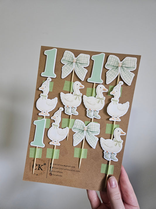 A set of handcrafted cake toppers featuring goose shapes and number one, designed for a Silly Goose themed birthday party.